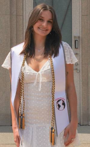 Photo of Grace Hasley standing in front of the clock tower at GVSU.